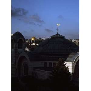  Weather Vane on a Church with a Mosque in Background 