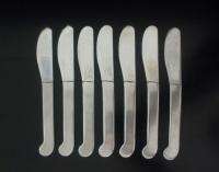 THIS AUCTION IS FOR 7 STAINLESS STEEL BUTTER SPREADERS MADE BY KNOBLER 