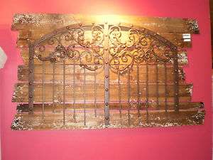 IRON GATE STYLE WALL GRILL MOUNTED ON RUSTIC WOOD PLANK BOARDS 